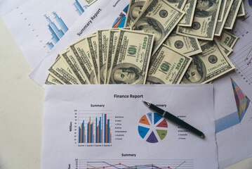 Office desk money bank note financial report business chart graph on wood table. Flat lay money...