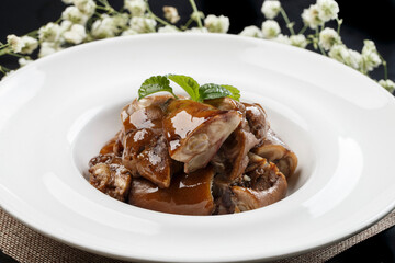 Delicious cold braised pig's trotters in a round white porcelain plate