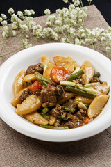 Braised pork with beans and yam fish on a white porcelain plate