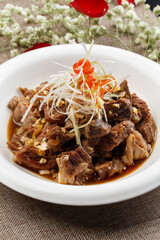 Braised lamb chops on white porcelain plate