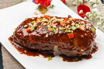 Duck breast with sauce served on a white porcelain plate