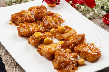 Braised chicken thighs with ginkgo nuts on a white porcelain plate