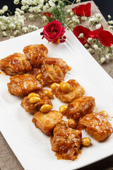 Braised chicken thighs with ginkgo nuts on a white porcelain plate