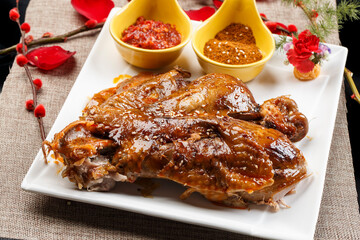 White porcelain plate of Mongolian speciality charcoal grilled lamb spine