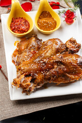 White porcelain plate of Mongolian speciality charcoal grilled lamb spine