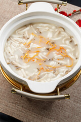 Cordyceps flower wild mushroom soup in a white porcelain bowl