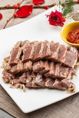 Crystal donkey meat on a white porcelain plate
