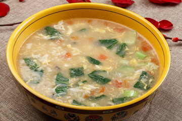 Popular gourmet dumpling soup in a yellow porcelain bowl