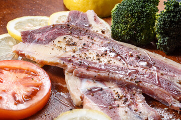 Australian beef ribs on a wooden chopping board