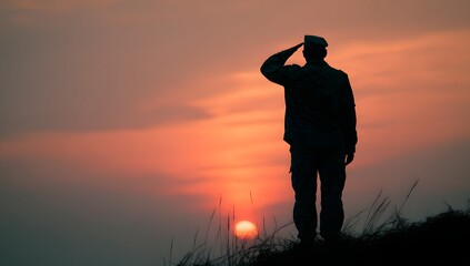 Silhouette of a soldier saluting at sunset.