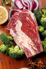 Beef belly brisket on wooden cutting board