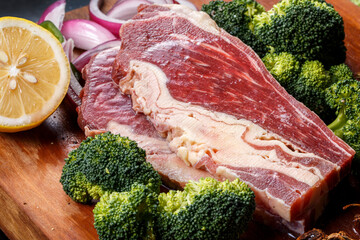 Beef belly brisket on wooden cutting board