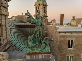 Angel statue with trumpet atop Saint-Jean-Baptiste Church in Montreal, Canada. The statue is a...