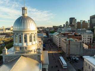 Aerial view of Bonsecours Market dome in Old Montreal, Canada. Tourists explore the historic...