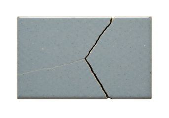 Cracked gray ceramic tile showing fragmentation and a linear split, ideal for representing breakage, damage, or texture.
