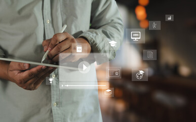 Educational video person using digital tablet with educational and learning icons floating around, symbolizing online education, digital learning