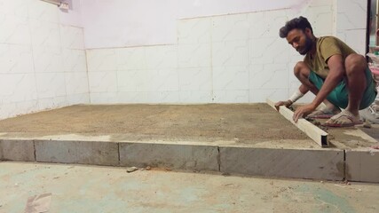 Worker smooth surface during shop renovation