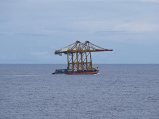 gantry cranes loaded on top a ship for industrial port