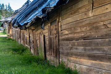 Close-Up of Old Wooden Shed Wall and Doors with Weathered Texture in Rural Area. Detail of...
