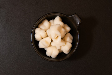 Close-up of Tteokbokki Rice Cakes in a Black Square Dish