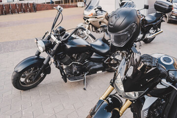 Sleek Black Motorcycles Parked with Helmet on Street