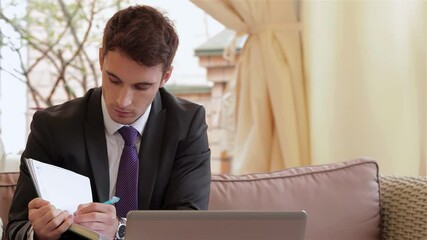 Focused businessman reviewing phonebook during a lunch meeting - Powered by Adobe