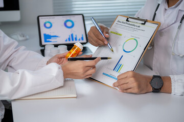A doctor and a patient are looking at a chart with a green circle on it