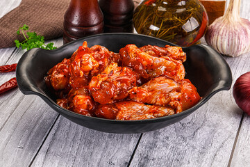 Raw marinated buffalo chicken wings