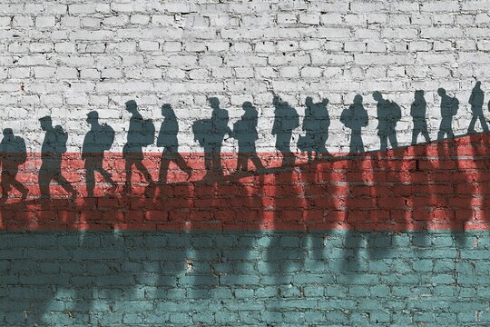 The refugees migrate to Europe union . Silhouette of illegal immigrants . Europe union migration policy. Flag of Belarus painted on a brick wall. High quality