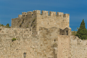 Marina Gate, or Saint Catherine's Gate, is the city's main gate. Two twin crenellated towers with a bas-relief depicting a Virgin and Child flanked by Saint Peter and Saint John the Baptist.in Rhodes