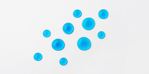 Blue drops of cosmetics on a white background