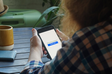 Travel planning. Tourist woman booking hotel using smartphone. Online payment for last minute tour. 