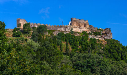 A majestic portuguese stone fortress perched atop a hill