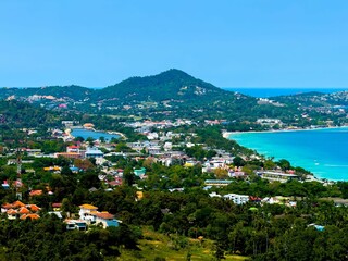 A high-angle, wide-shot captures a breathtaking panoramic view of a bustling coastal town, where...