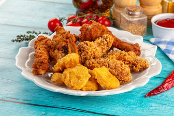 Golden crispy fried chicken mix - wings, drumsticks, nuggets and strips