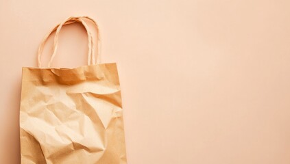 Light beige paper shopping bag on pale peach background