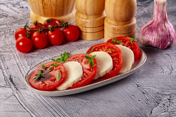 Italian caprese salad with mozzarella, tomato and basil