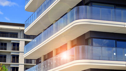 Exterior of a high modern multi-story apartment building - facade, windows and balconies. Modern...