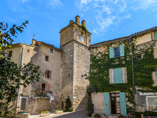 The clock tower in the medieval village of Saignon in Provence, France.  Saignon is one of the ten...