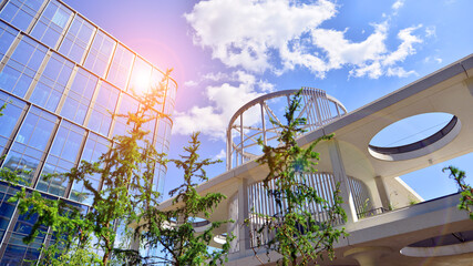 Sustainable glass office building with trees for reducing carbon dioxide. Eco-friendly building in...