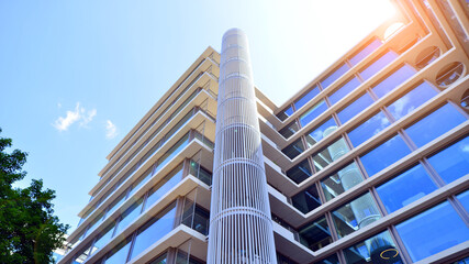 Sustainable glass office building with trees for reducing carbon dioxide. Eco-friendly building in...