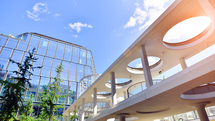 Sustainable glass office building with trees for reducing carbon dioxide. Eco-friendly building in...