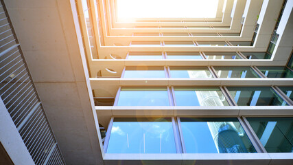 Modern office building with glass facade. Transparent glass wall of office building. Reflection of...