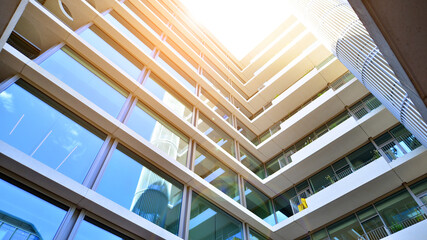 Modern office building with glass facade. Transparent glass wall of office building. Reflection of...