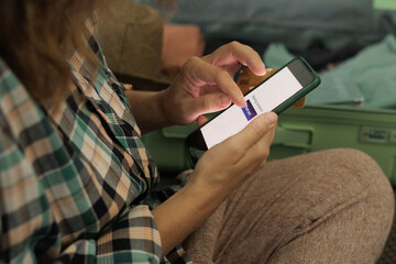 Travel planning. Person booking tour using smartphone. Online payment for last minute tour. 