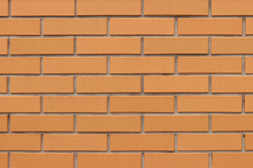Brick wall texture, background. Orange brick wall background for exterior design. Construction concept, outdoor buildings, garage or house. Wall with classic checkerboard pattern and visible joints