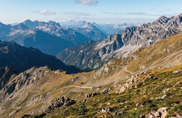 Aerial photo of winding Maloja Pass road in Swiss Alps. Scenic mountain landscape with peaks valleys. Travel adventure, explore nature, road trip. Switzerland, Europe, driving.