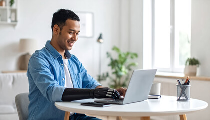 Person with a prosthetic hand typing on a laptop or using a tablet in a modern workspace