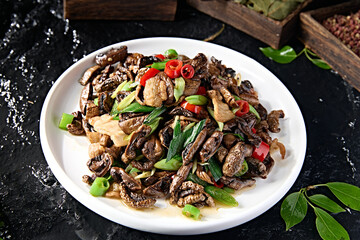 Stir-fried pork belly with dried mushrooms and garlic sprouts