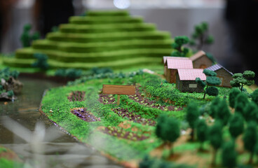 Miniature scene of farming village and rice terraces, traditional rural way, handcrafted diorama...